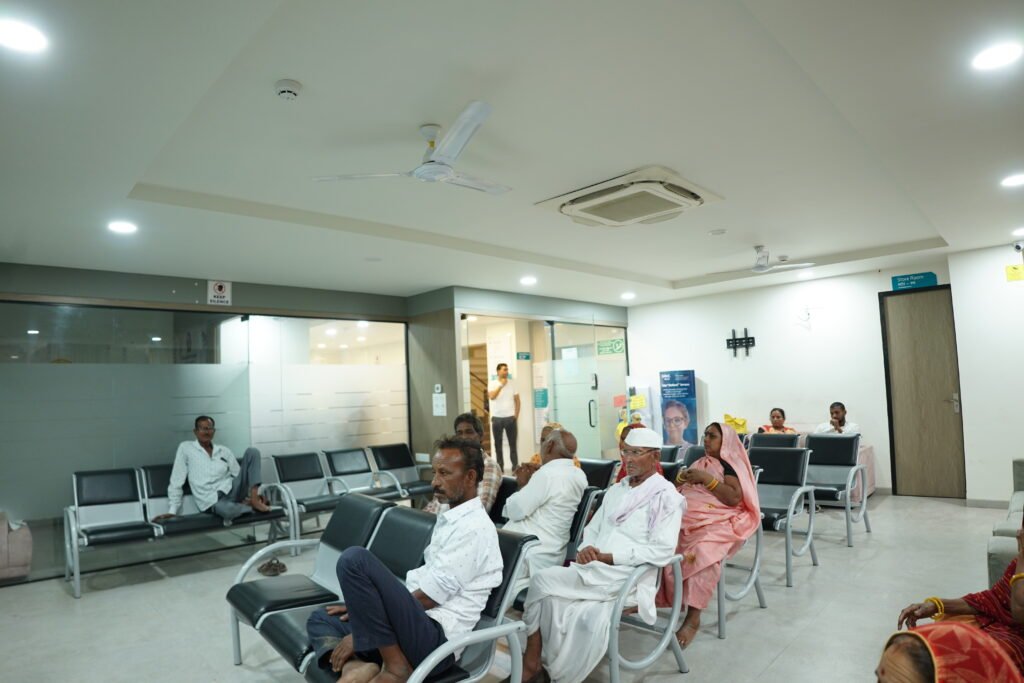 A group of patients seated in chairs in a waiting room at a retina specialist's office
