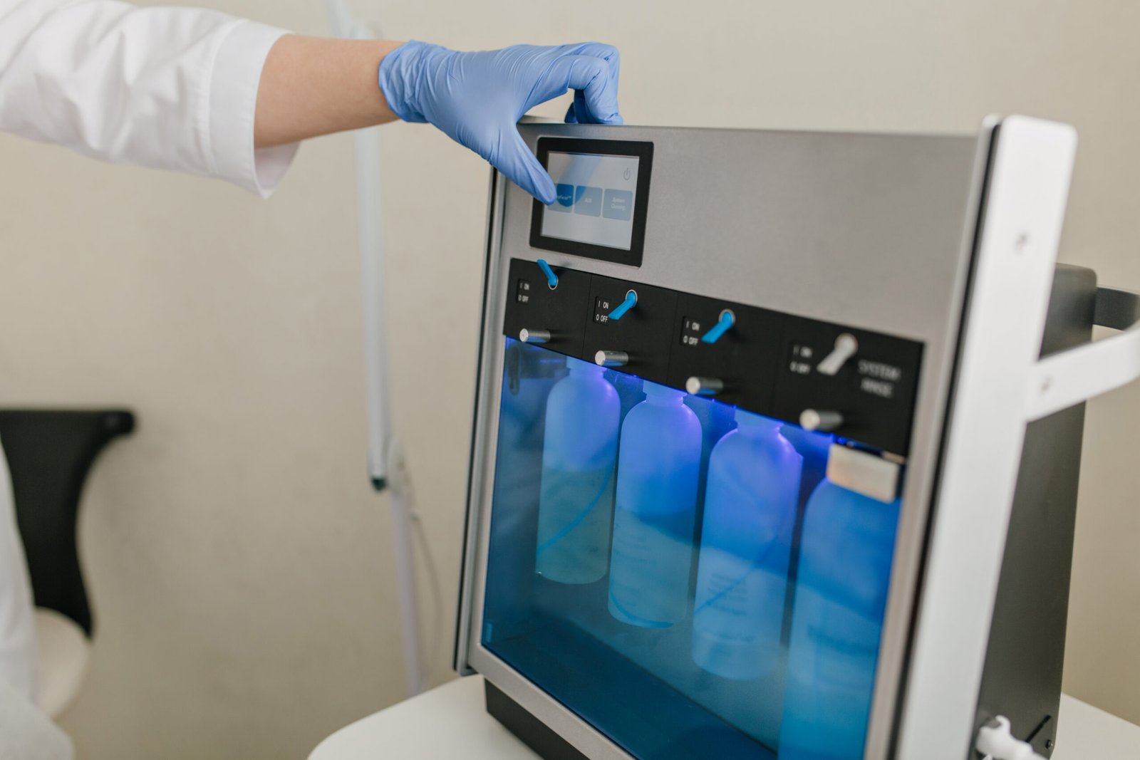 A person in a lab coat holds a medical machine, representing advanced technology at an eye hospital.