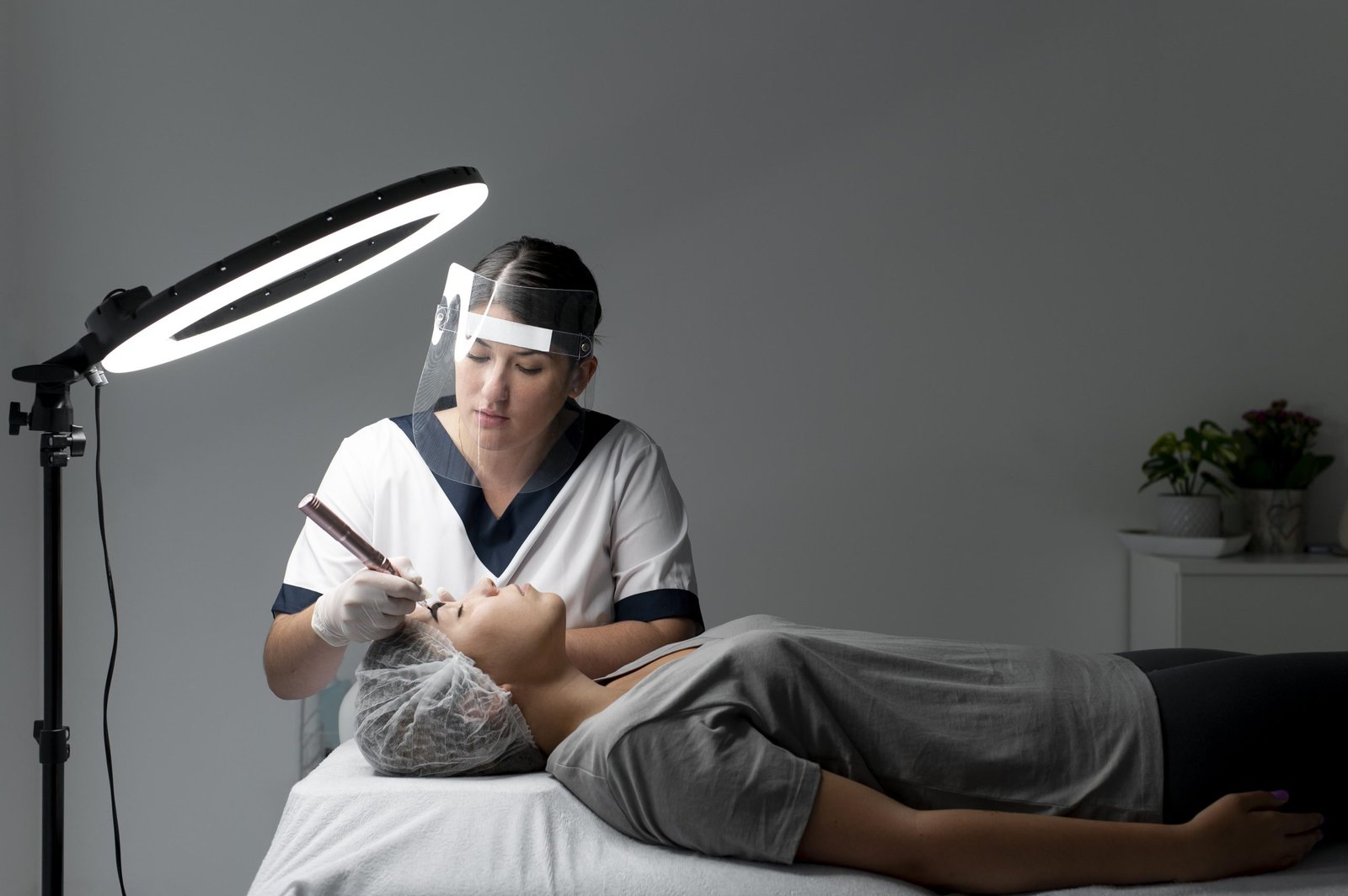 A woman receives a hair treatment from a retina specialist doctor in a clinical setting.